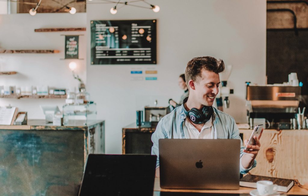 Man using smartphone and smiling