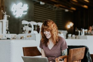 Woman using a computer and smiling