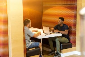 Two men sitting opposite each other