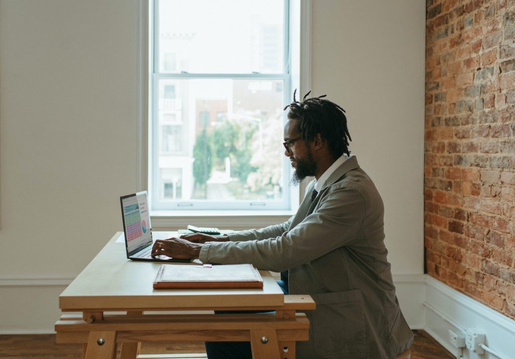 Black man operating a laptop