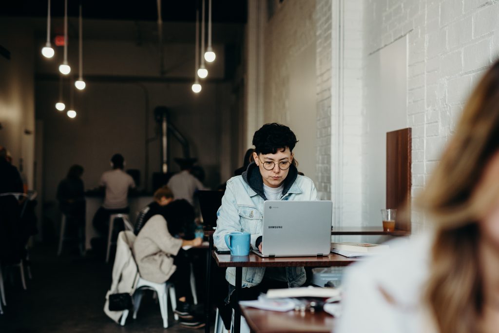 Man wearing a white jacket using a computer