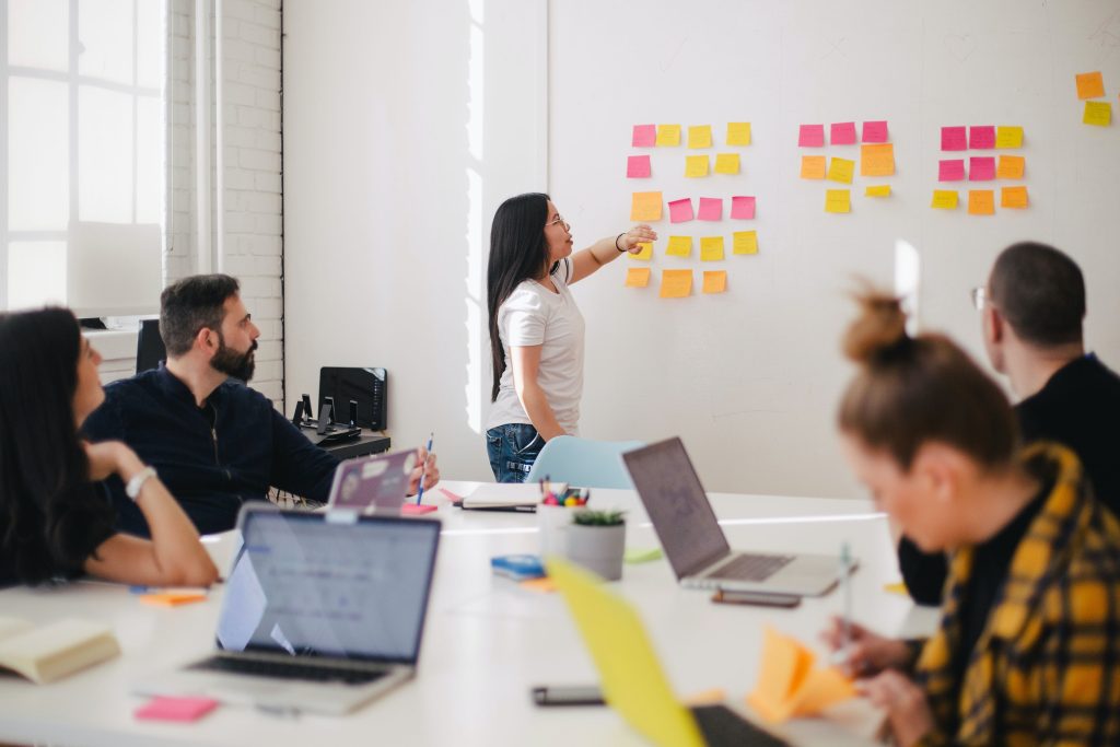 Woman placing sticky notes on a wall