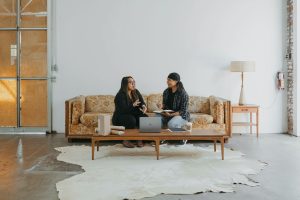 Two women sitting on a couch