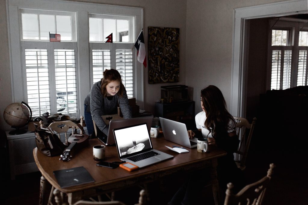 Woman using laptop on brown wooden table