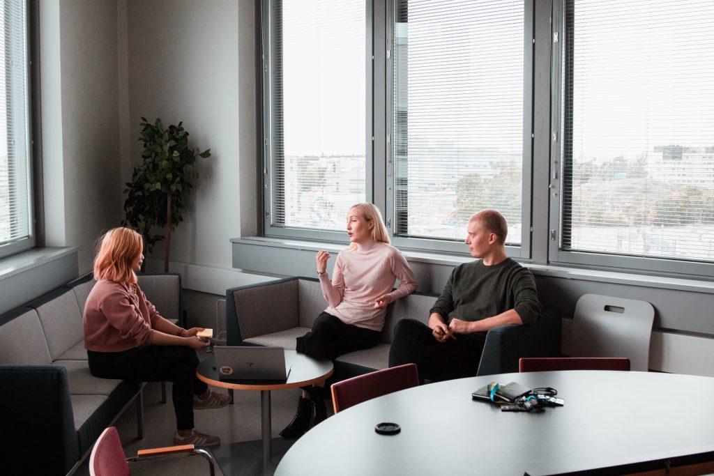 Three people sitting on a sofa